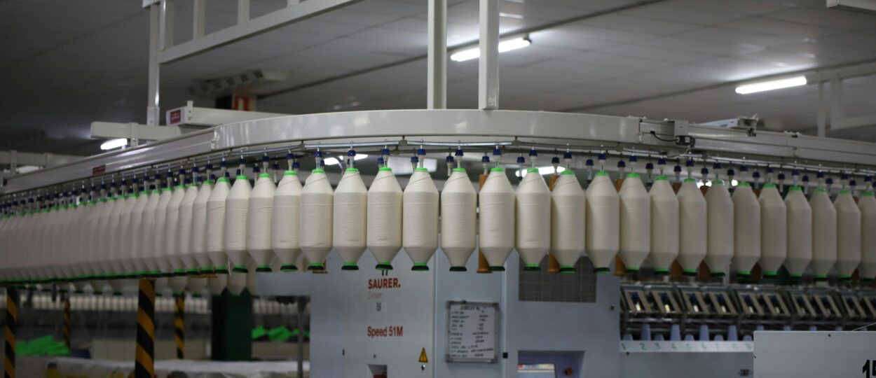 Industrial textile factory with yarn production line showcasing automated machinery for efficient manufacturing.